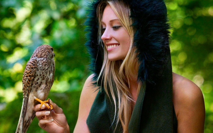 Woman with a bird in a forest