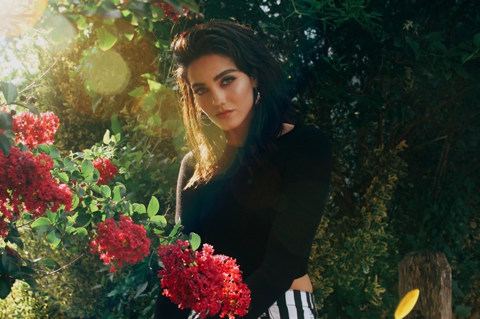 Woman with red flowers and lens flare