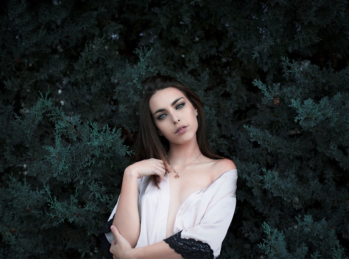 Woman with dark hair and blue eyes wearing a robe