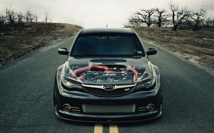 Subaru WRX STI with exposed engine on a road