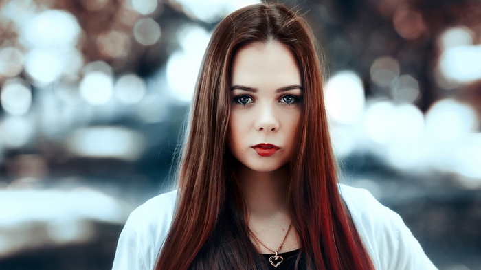Woman with long brown hair and red lipstick