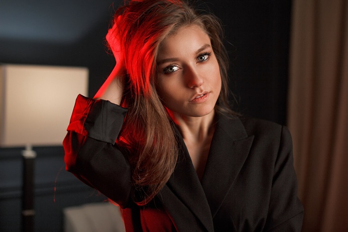 Woman with long brown hair in a black coat