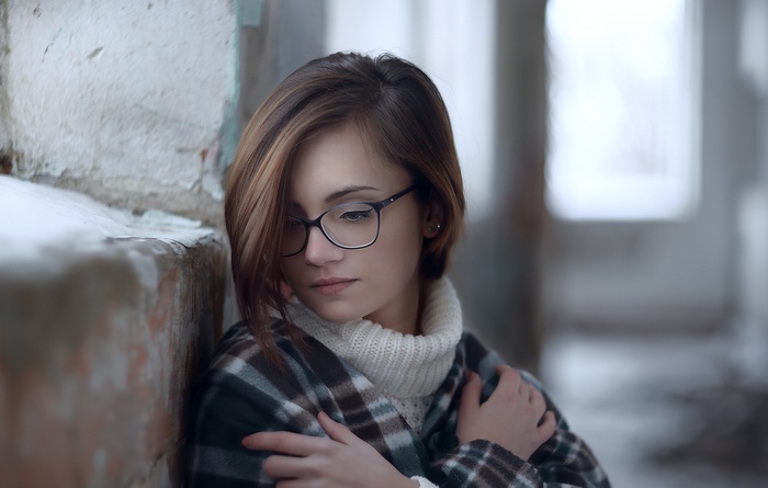 Woman wearing glasses and a plaid scarf
