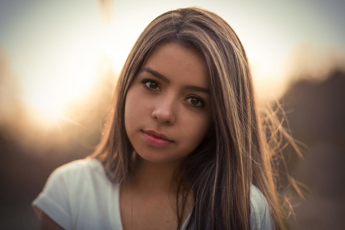 Portrait of a young woman with long brown hair