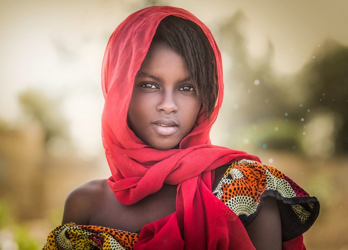 Portrait of a young girl with a red headscarf