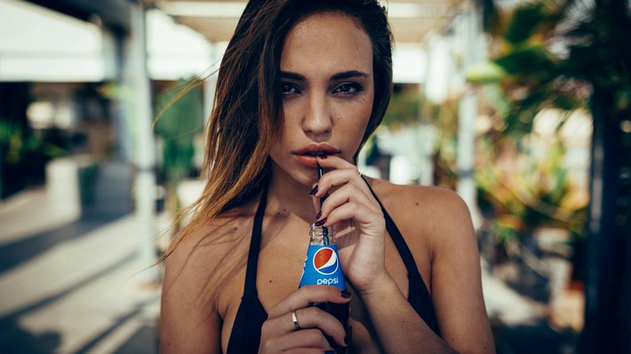Woman drinking Pepsi from a bottle