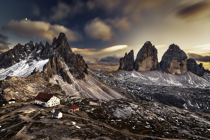 Mountain landscape with buildings and dramatic sky