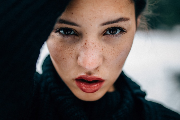 Woman with freckles and red lipstick