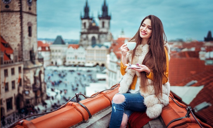 Woman drinking coffee on Prague rooftops
