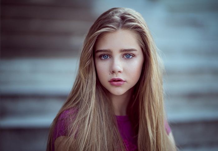 Portrait of a young woman with blonde hair and blue eyes