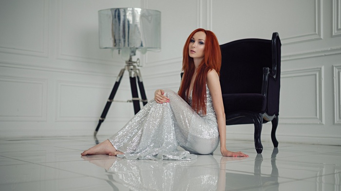 Woman in a sequined dress sitting on the floor