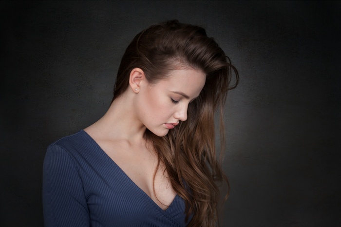 Woman with long brown hair in a blue shirt