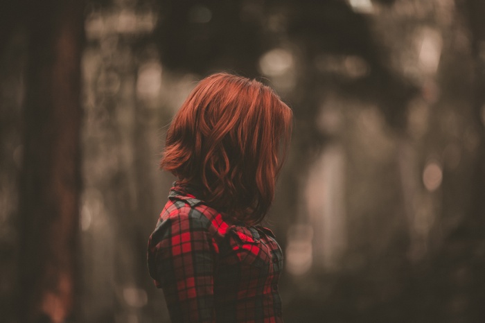 Woman with red hair in a forest