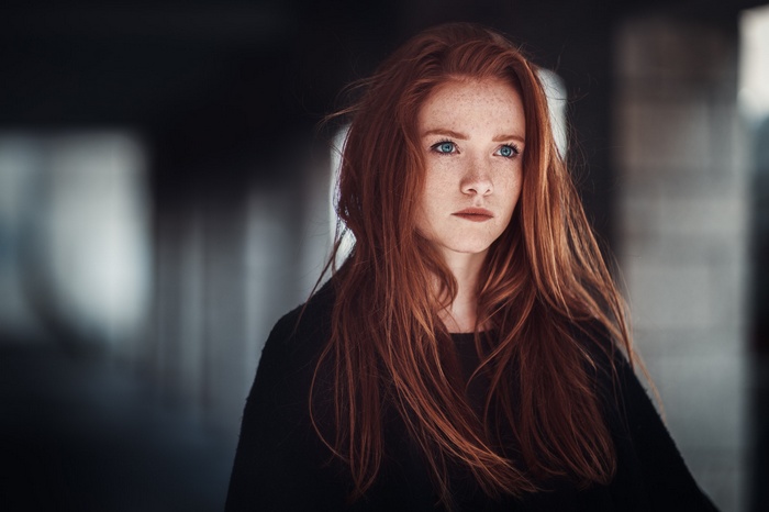 Redhead woman with blue eyes and freckles