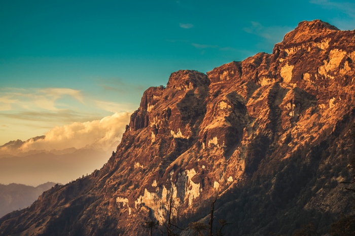 Golden mountain range under a blue sky