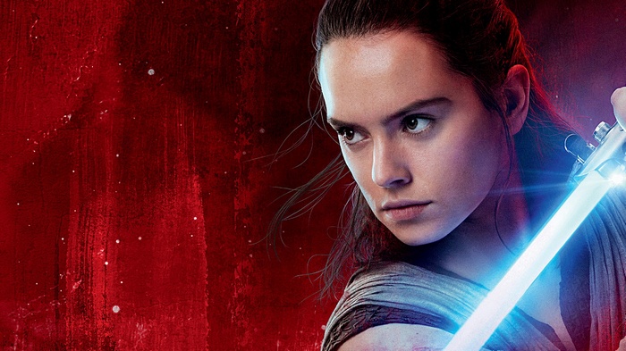 Rey from Star Wars: The Last Jedi holding a lightsaber