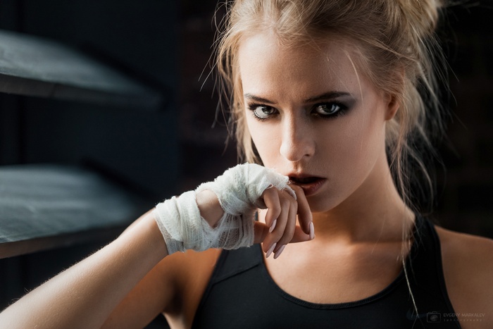 Portrait of a blonde woman with boxing hand wraps