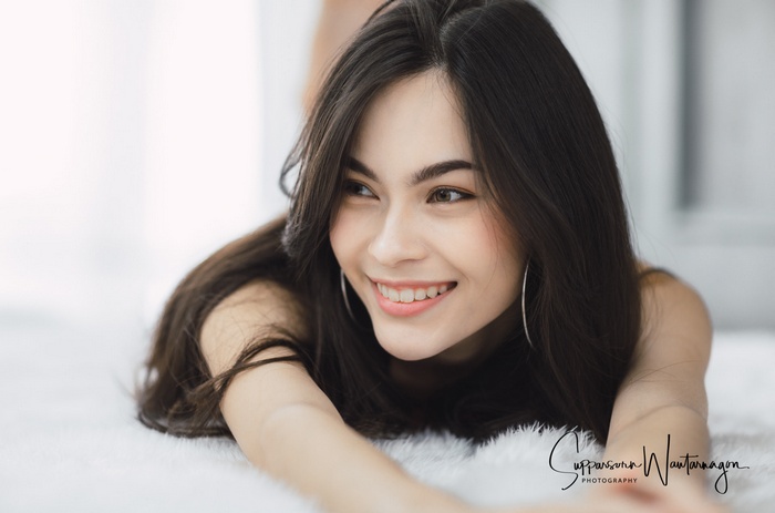 Asian woman with long dark hair smiling