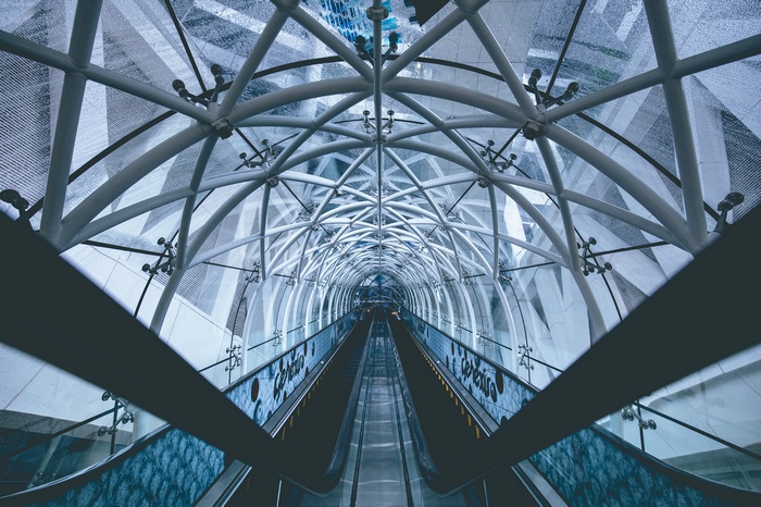 Modern architecture with escalators and glass ceiling