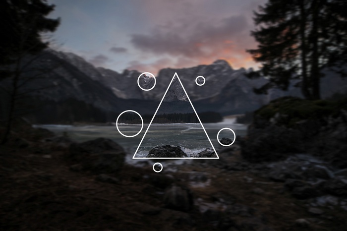 Geometric overlay on mountain landscape with lake