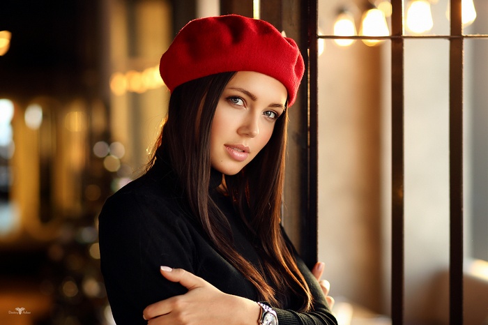 Elena with long brown hair wearing a red beret