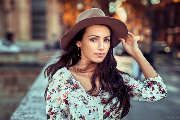 Woman wearing a hat and floral shirt