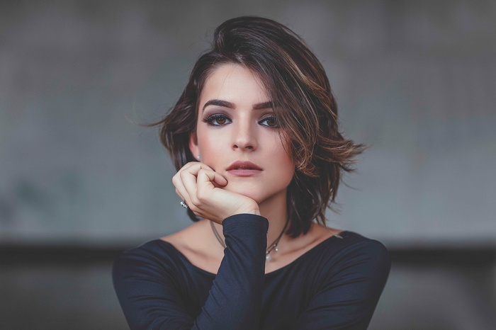 Portrait of a young woman with brown hair and eyes