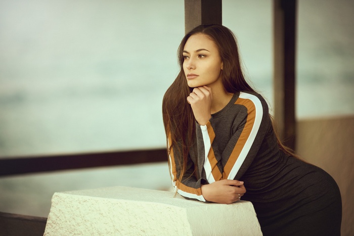 Woman in a dress looking away