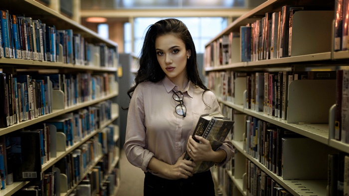 Woman holding books in a library