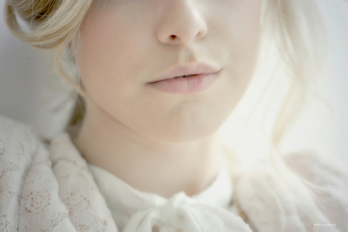 Close-up of a blonde woman's face with an open mouth