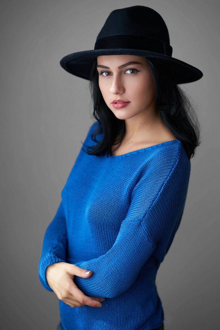 Woman in blue sweater and black hat