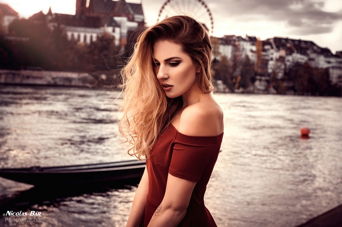 Woman in red dress by the river