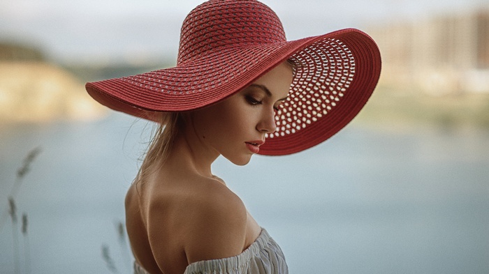 Woman in a red hat by the water