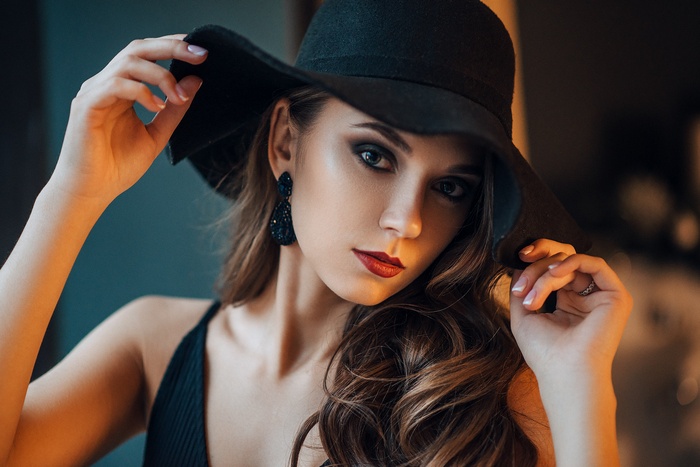 Woman in a black hat with red lipstick