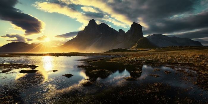 Sunset over mountains and water