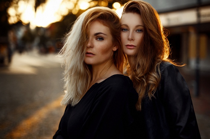 Two women with blonde and red hair outdoors