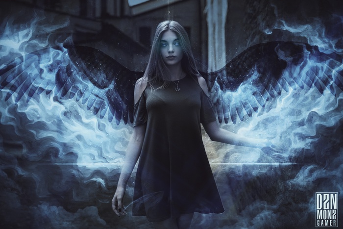 Woman with dark angel wings and blue smoke