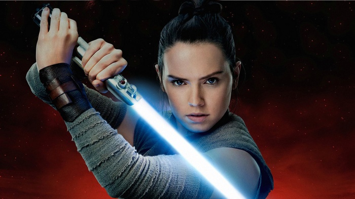 Rey from Star Wars holding a lightsaber