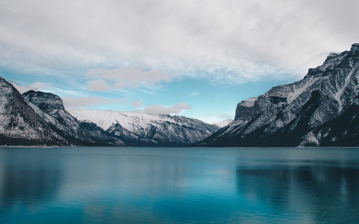 Snow-capped mountains reflected in a blue lake