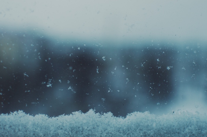 Snowflakes on a window pane in winter
