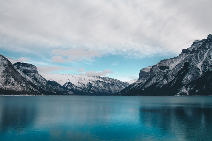 Snow-capped mountains reflecting in a blue lake