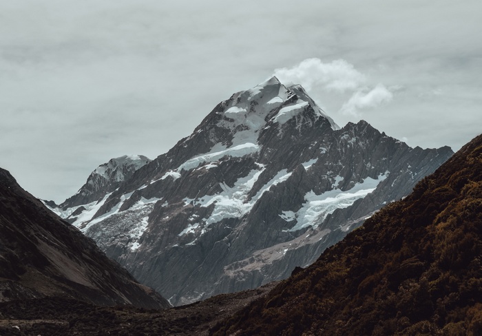 Snow-capped mountains under a cloudy sky
