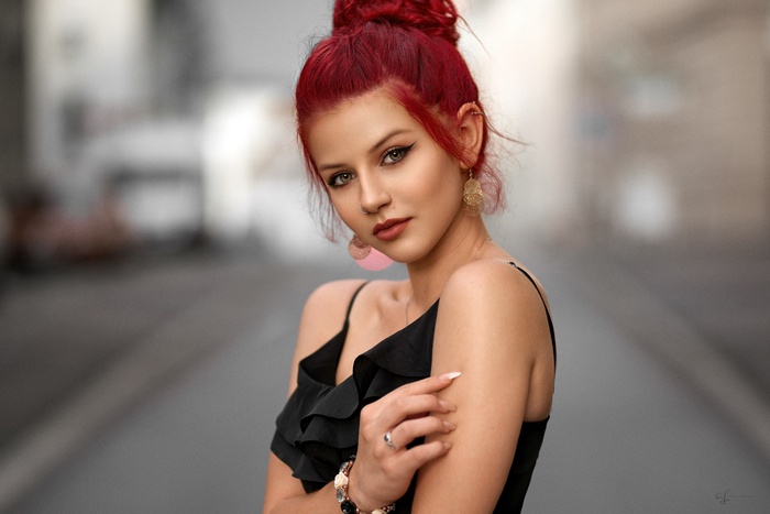 Woman with red hair in a black dress