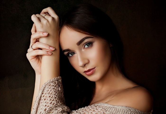 Portrait of a young woman with green eyes and brunette hair