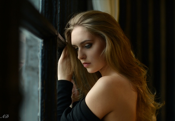 Woman with blonde hair by the window