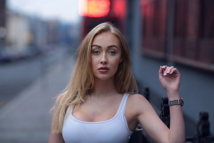 Woman with blonde hair and blue eyes outdoors