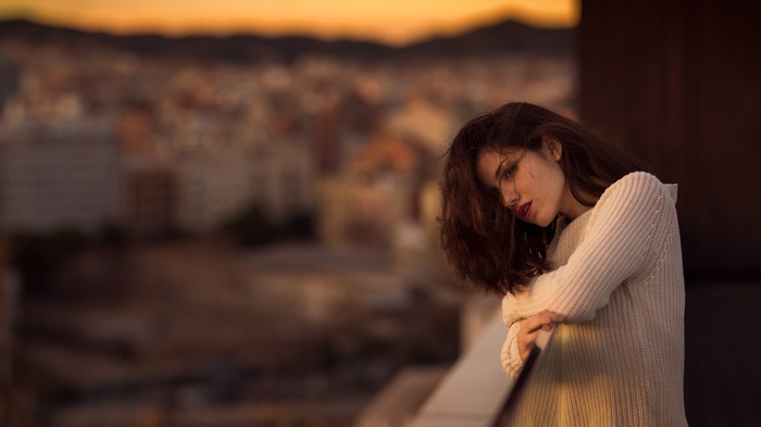Woman with red lipstick and white sweater outdoors