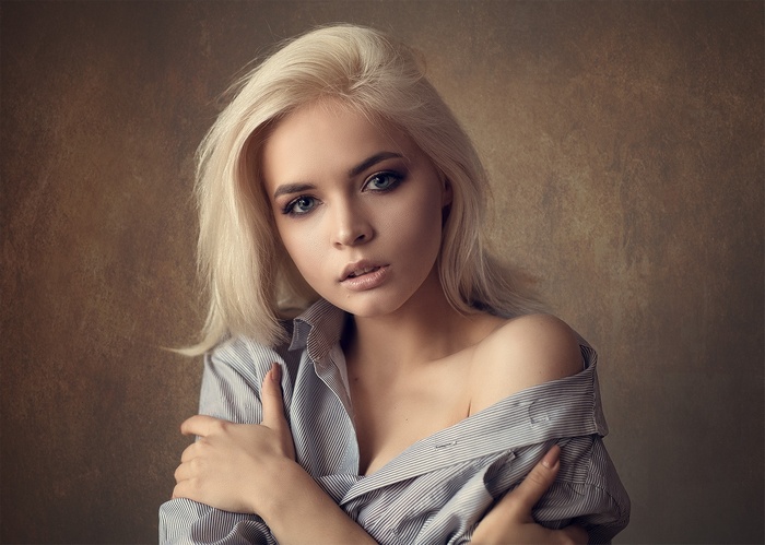 Portrait of a blonde woman in a striped shirt