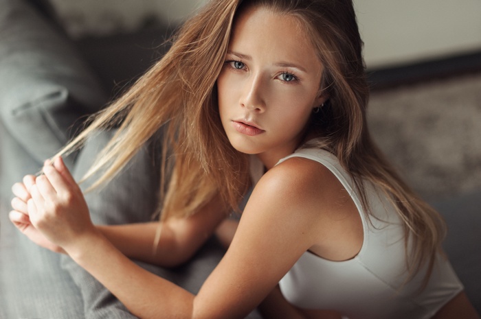 Woman with blonde hair in a white top