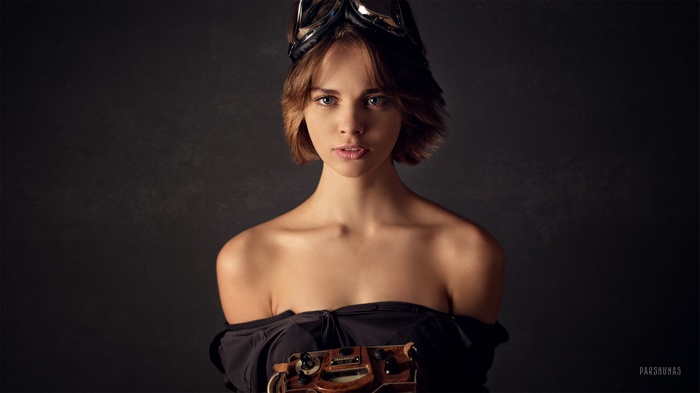Woman with goggles and vintage device by Anton Parshunas